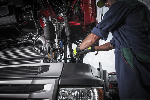 Technician Repairing Engine