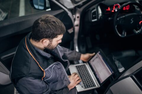 Mechanic performing car diagnostics