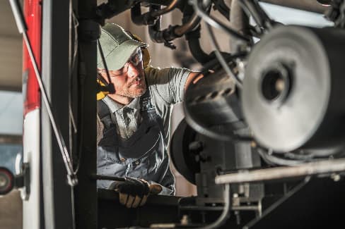 Automotive technician performing diesel truck service