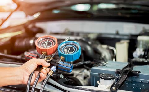 Technician checking vehicle HVAC system